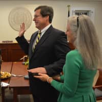 <p>Don Scott takes his oath of office with his wife, Stephanie, at the the right. Town Clerk Boo Fumagalli, left, administers the oath.</p>