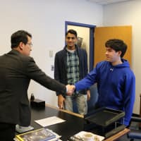 <p>New Principal Keith Yi shakes hands with a Walter Panas High student.</p>