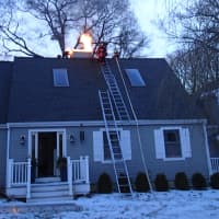 <p>Westport firefighters respond to a chimney fire on Jackie Lane on Sunday.</p>