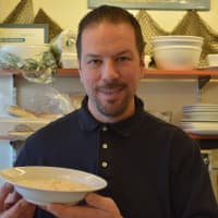 <p>La Mer Seafood owner Edward Weschler with a bowl of New England clam chowder.</p>