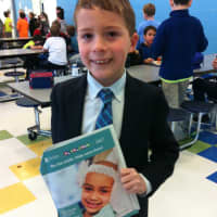 <p>Fourth grader Matthew shows off the math book he is using for Milton School&#x27;s Math-A-Thon.</p>