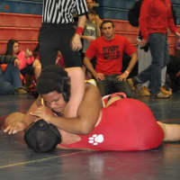 <p>Norwalk Mad Bulls wrestler Nemo Harris tries to put the finishing touches on an opponent.</p>