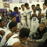 <p>Huguenots coach Rasaun Young talks to his players during timeout.</p>