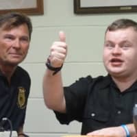 <p>Patrick Kogut gives a thumbs up after he was handed an envelope with money and gift cards donated by police and citizens. Kogutt, who is autistic, was robbed of $100 money in birthday money by Steven St. Jacques.</p>