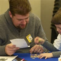 <p>Cortlandt Manor resident Eric Rauschenbach and son, Aaron, 5, work on their drawing for MLK day.</p>