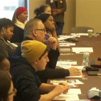 <p>Attendees discuss training adults on how to interact with kids, and dealing with racism.</p>