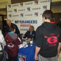 <p>Adam Graves, standing at left, and Glenn Anderson, seated, swapped hockey win memories as they signed autographs in Rye on Tuesday.</p>