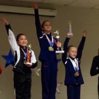 <p>Darien YMCA gymnast Jamie Santella won the Level 4 All-Around title and Emma Neaderland was third for their age group at the Flippers Invitational in Glastonbury. </p>