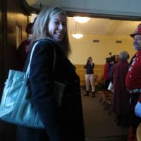 <p>Dresses as an 1891-era firefighter, Ray Maldonado greeted Debbie Manetta as she entered Larchmont Village Hall.</p>