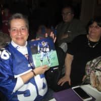 <p>Tracey Traverson shows off her Lawrence Taylor autograph.</p>
