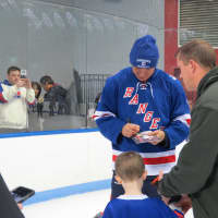 <p>Stephane Matteau was one of six New York Ranger greats to sign autographs before the game.</p>