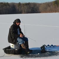 <p>Bedford resident Warren Hensel ice fishing on the Cross River Reservoir.</p>