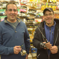 <p>Charles George, left, owner of The Bedford Sportman, with Carmel resident John Desatnik. The two pose for photos while holding equipment.</p>