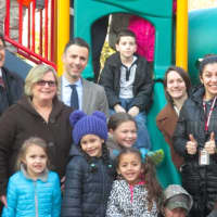 <p>Park Childhood Center students, school officials and developer Martin Ginsburg gathered to celebrate the construction of a new playground for the center. </p>