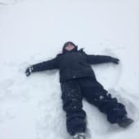 <p>Jakob makes a snow angel.</p>