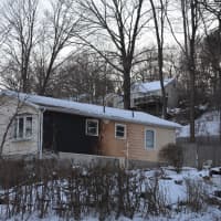 <p>Sunday&#x27;s devastating house fire in Mahopac Falls also damaged the siding of a neighboring home, pictured in the background.</p>