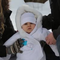 <p>Nick and Jess Iannacone give daughter Madison a hand as she stands on the snow. </p>