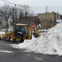 <p>A bulldozer was needed to clear snow Thursday at the Harrison Shopping Center.</p>