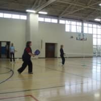 <p>Pickleball is played on a badminton-sized court and a slightly modified tennis net.</p>