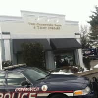 <p>A Greenwich police officer can be seen inside the bank branch. </p>
