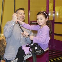 <p>Emma Hendricks, 6, of Wilton, gets a lift with the help of dad, Jerry.</p>
