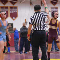 <p>Sam White of the Norwalk Mad Bulls has his arm raised in victory after stunning state champion Hunter Adams in the finals of a tournament last weekend in South Windsor.</p>