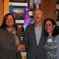 <p>Tree Conservancy of Darien board members Karen Hughan, left, and Sabina Harris, right, stand with Stanley Malecki, winner of Best in Show at the 2014 Celebration of Trees photography contest.</p>
