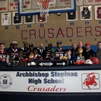 <p>Archbishop Stepinac athletes are joined by their family and school coaches and officials as they sign letters of intent to play college sports on Wednesday.</p>