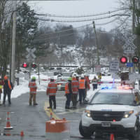 <p>Workers checked the signals at the intersection where the fatal crash took place.</p>