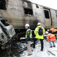 <p>NTSB officials survey the crash scene.</p>