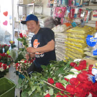 <p>Hidenori Takada, owner of Oishinbo Japanese Grocery in Harrison, preparing roses for Valentine&#x27;s Day.</p>
