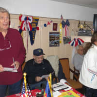 <p>Harrison VFW Commander Fred Neale, left, and other veterans look at Valentine&#x27;s cards distributed by Armonk students.</p>