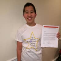 <p>New Rochelle middle school student Jake Gallin shows off his letter naming him one of two New York finalists.</p>