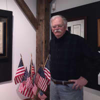<p>Darien Historical Society Historian Ken Reiss with some of the presidential signatures in the exhibit &quot;Signed by the President&quot;</p>