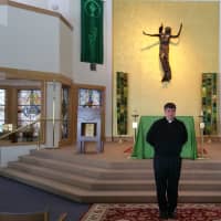 <p>The Rev. Bret Stockdale, S.J., stands in front of the alter at Egan Chapel on Fairfield University&#x27;s Campus.</p>