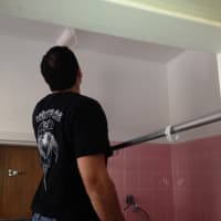<p>A brother knight repaints a bathroom at The Malta House. </p>
