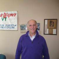 <p>Greenburgh Supervisor Paul Feiner standing next to a banner from a fundraising bicycle ride he made with the late John Kennedy Jr. and Robert Kennedy Jr.</p>