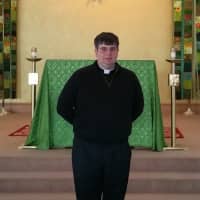 <p>The Rev. Bret Stockdale, S.J., stands in front of the alter at Egan Chapel on Fairfield University&#x27;s Campus.</p>