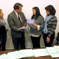 <p>Harrison Central School District Advocacy Committee members hand petitions to state Sen. George Latimer, D-Rye</p>