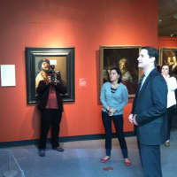 <p>U.S. Rep. Jim Himes, D-Conn., looks at some of the art on display at the Bruce Museum while Tara Contractor explains the history and backgrounds of the paintings and the painters.</p>