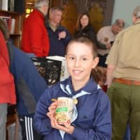 <p>Pack 23 Cub Scout Solomon Hochman collects food at last years annual Scouting for Food drive, benefiting Neighbor to Neighbor. This years event is on Saturday, March 7.</p>