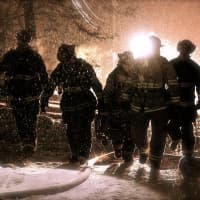 <p>Westport firefighters fight a blaze at a home on Weathervane Hill Wednesday night.</p>