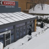 <p>Outdoor seating at Chipotle Grill is buried in snow at the Danbury Fair Mall.</p>
