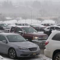 <p>Snow falls on the packed parking lot at the  Danbury Mall.</p>