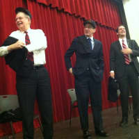 <p>Gov. Dannel P. Malloy, center, shares a laugh with U.S. Rep. Jim Himes, right, and Stamford Mayor David Martin, as Martin slips on a Stamford High T-short following a senior class assembly with the three politicians.</p>