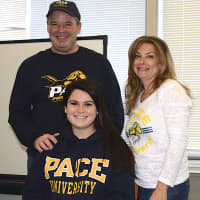 <p>Sarah Bard, a senior at Lakeland High School, meets with her parents after signing a letter of intent to play field hockey at Pace University.</p>