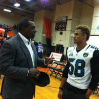<p>Former NFL player Craig Bingham talks with current Jacksonville Jaguar player Khairi Fortt at the Stamford High Pride Day. Bingham graduated in 1978 while Fortt graduated in 2010.</p>