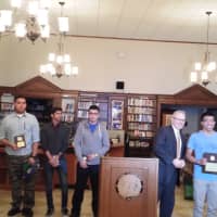<p>Port Chester High School Principal Mitchell Combs presents the top prize to Christopher Chino. The other four award winners are left of Combs.</p>