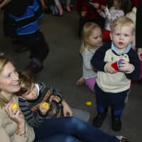 <p>Opus Board Member Tasha Blair helps her children Lachlan (5) and Sawyer (2) keep the beat at the Snowflakes, Songs &amp; Slices benefit concert.</p>