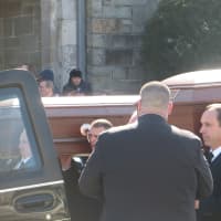 <p>The caskets for Alissa and Deanna Hochman glisten in the sunlight as they are carried out of St Gregory the Great Church in Harrison</p>